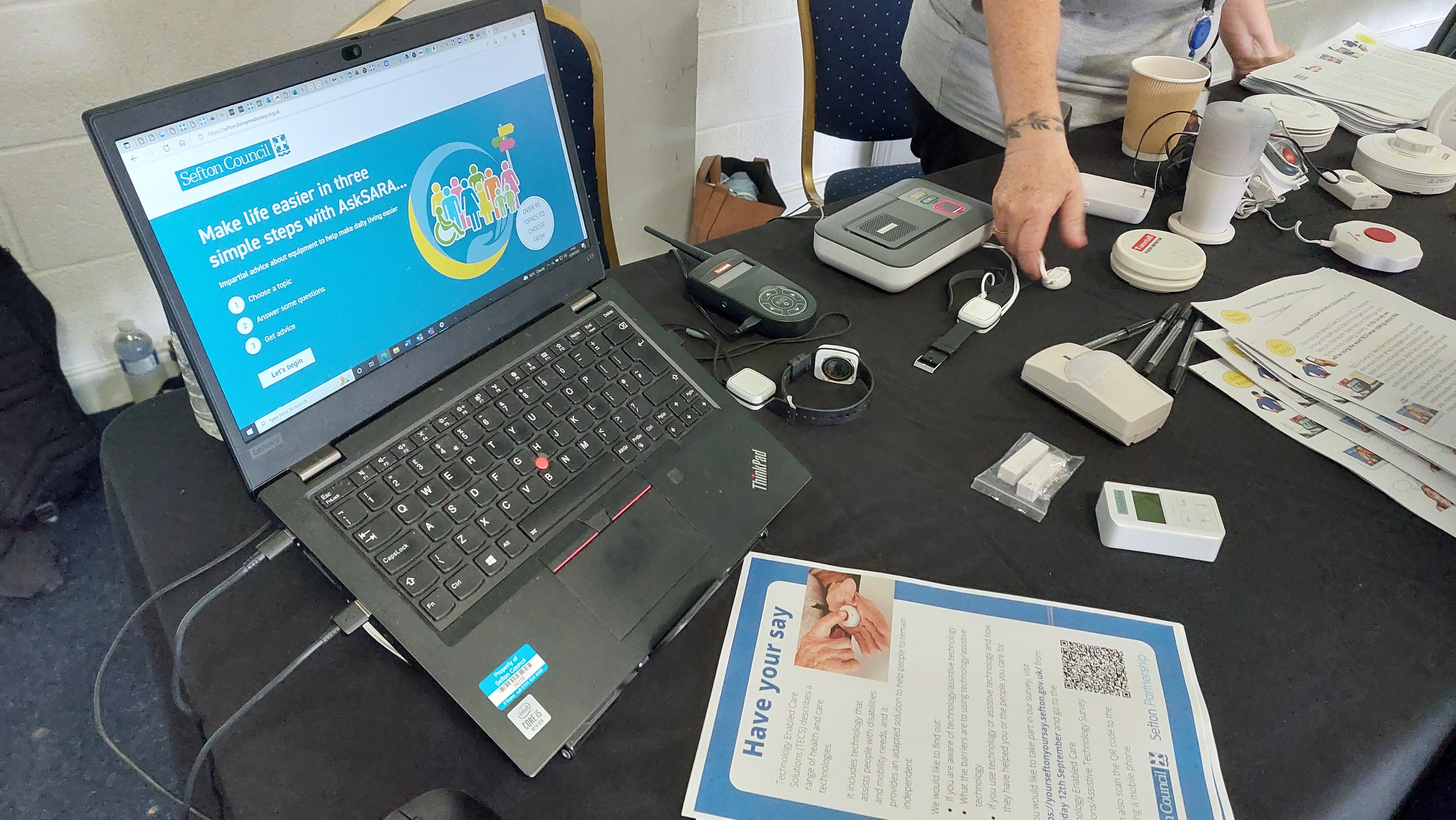 An image of a laptop and some alarms and sensors on a table