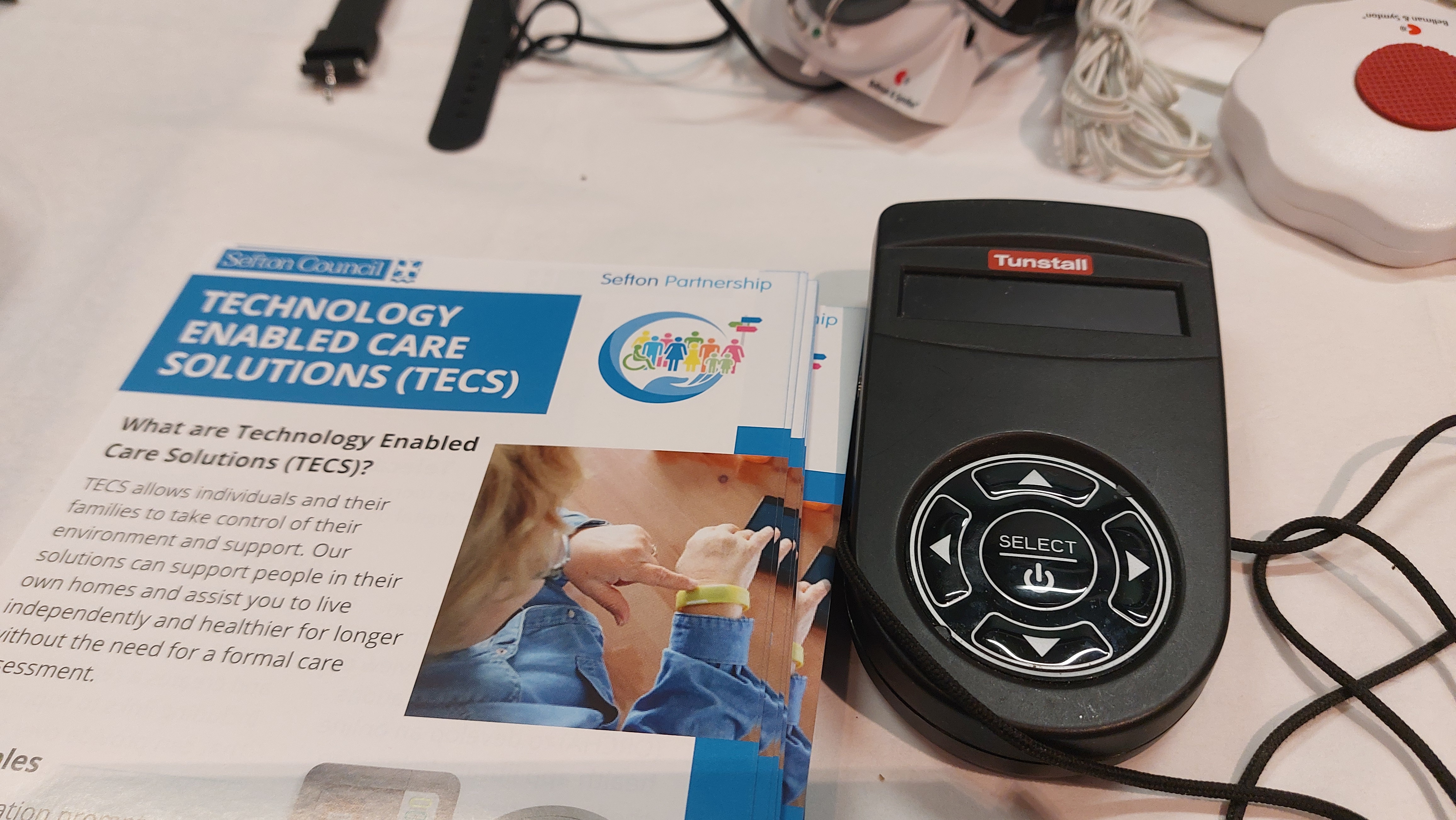 An image of an information leaflet and some technology to help people stay safe in their homes
