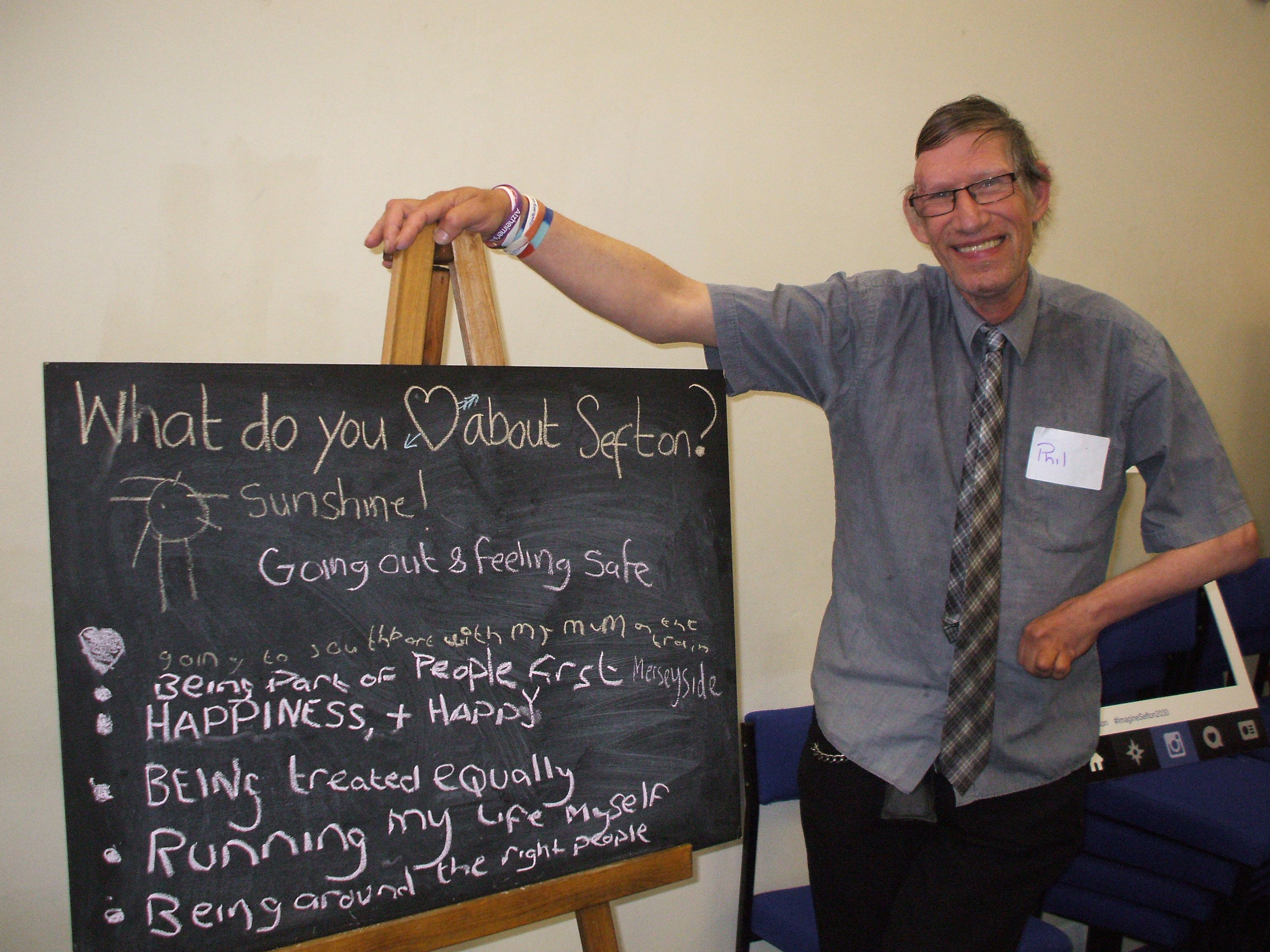 A man standing by a chalkboard