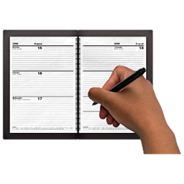A hand writing in a diary