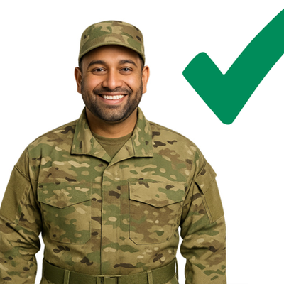 A smiling soldier with a green cross