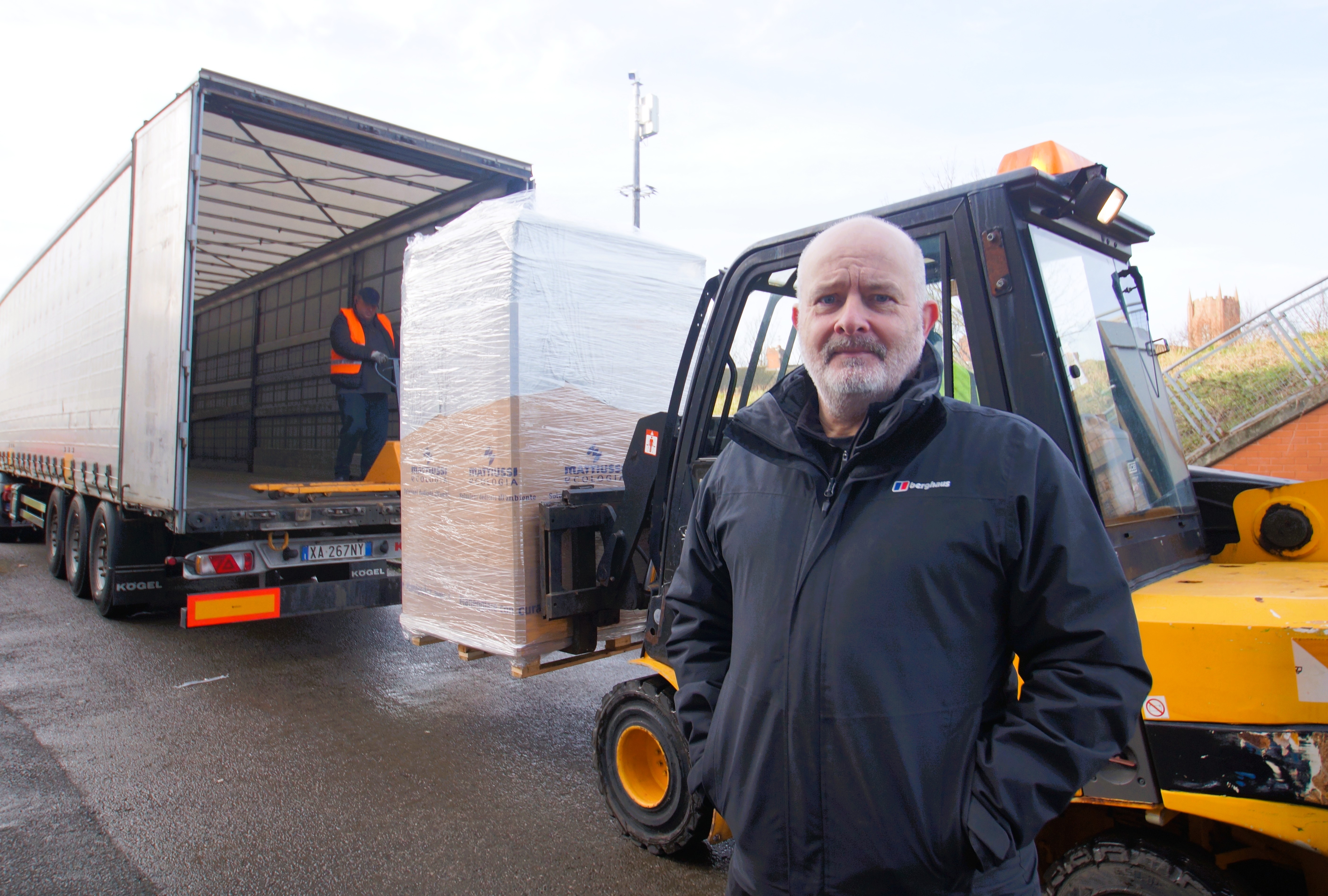 A man standing near a food waste truck